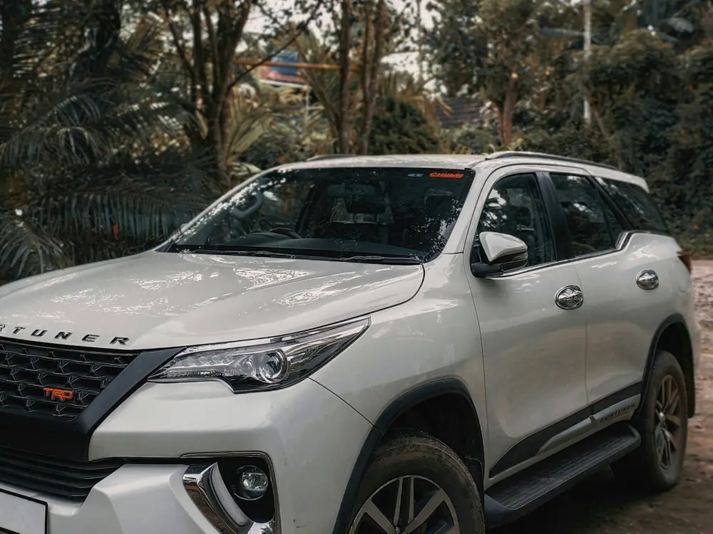 White Toyota Fortuner Legender under palm trees