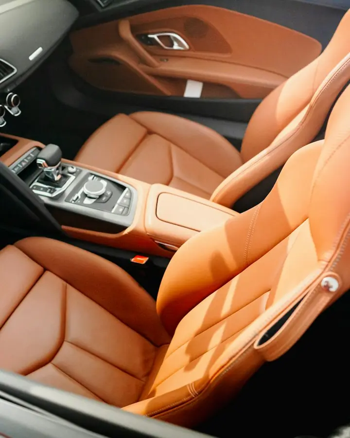 Driver's seat view: tan leather seats and steering wheel